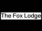 Luxury winter lodge in Big Bear surrounded by snow, showcasing warm cabin lighting and modern mountain design.