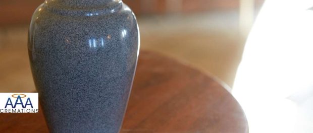 Handcrafted urn, memorial jewelry, and framed photo arranged together as personalized cremation keepsakes.